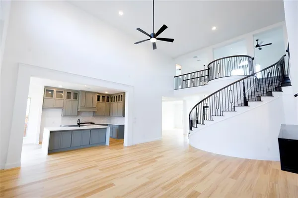 a view of entryway and kitchen with wooden floor