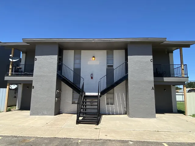 a view of a house with a wooden fence