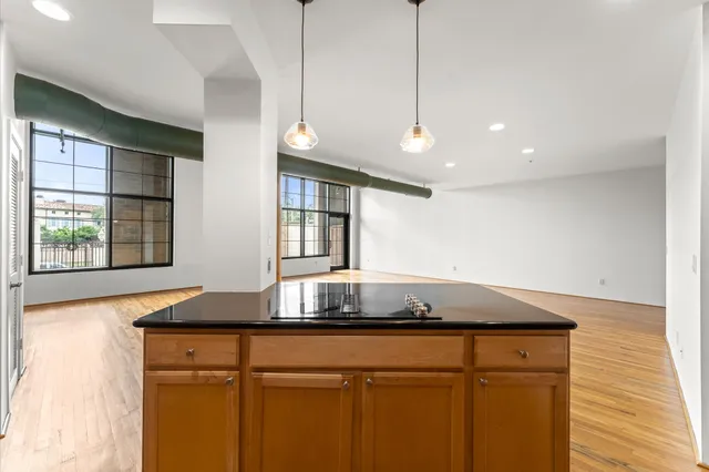 a kitchen with stainless steel appliances granite countertop a stove and a refrigerator