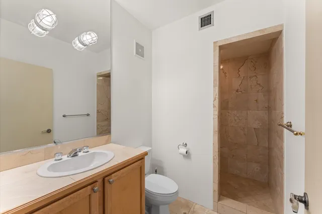 a view of a hallway with wooden floor and stairs