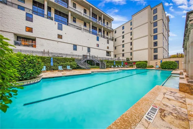 a view of a patio with couches chairs potted plants and city view