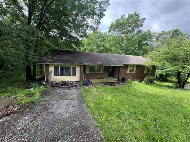 a front view of a house with yard patio and green space