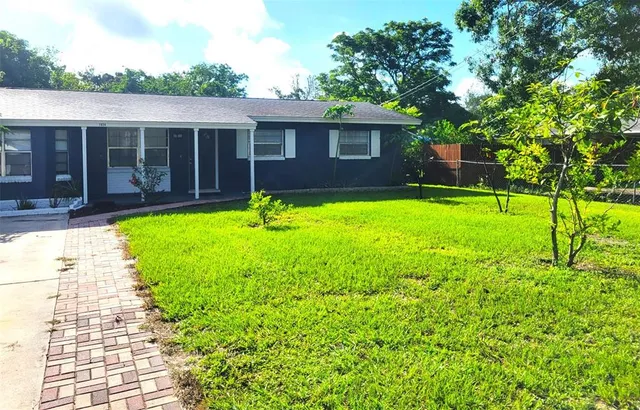 a front view of house with yard and green space