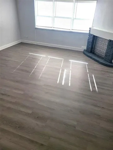 a view of room with window and hardwood floor