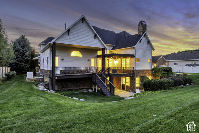 259 Twin River Loop Alpine, UT 84004 - Photo 46 of 61 Half acre lot, large covered back deck, covered patio on the basement level, two-story exterior with horizontal siding, shingle accents, a covered deck, and an expansive lawn.