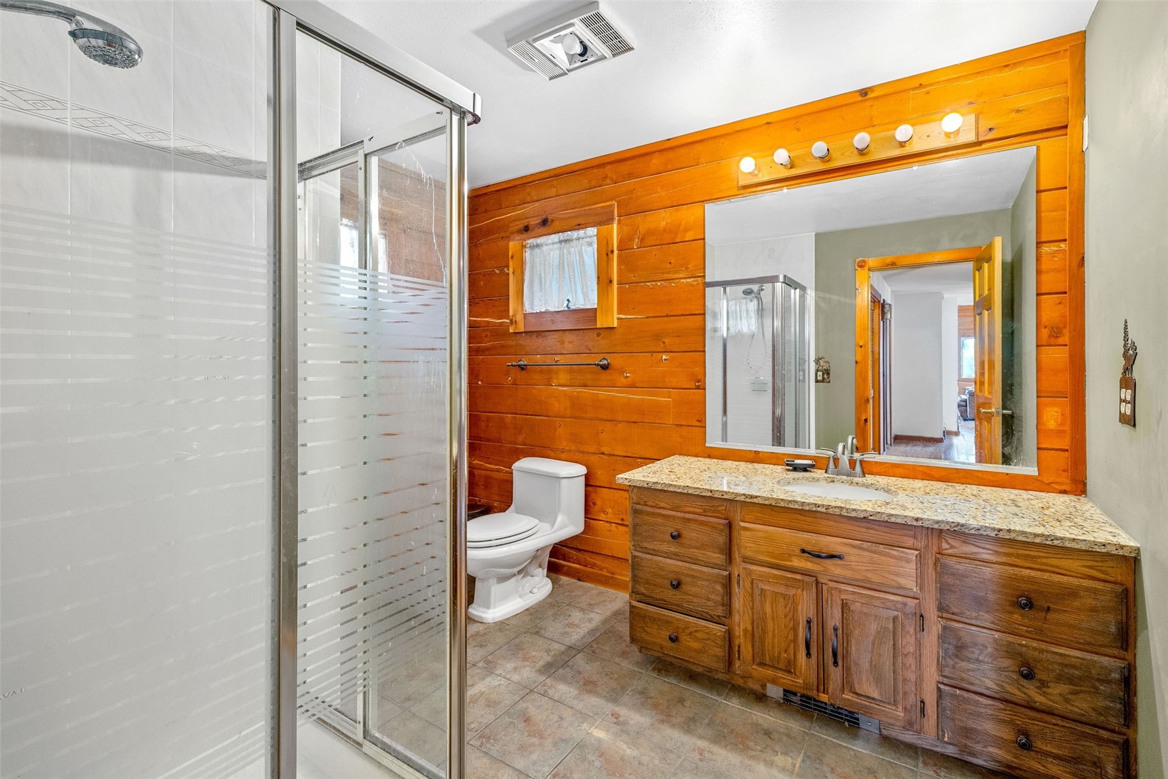 597 Sheep Ridge Road Fairplay, CO 80440 - Photo 15 of 50 a bathroom with a granite countertop sink mirror vanity and toilet