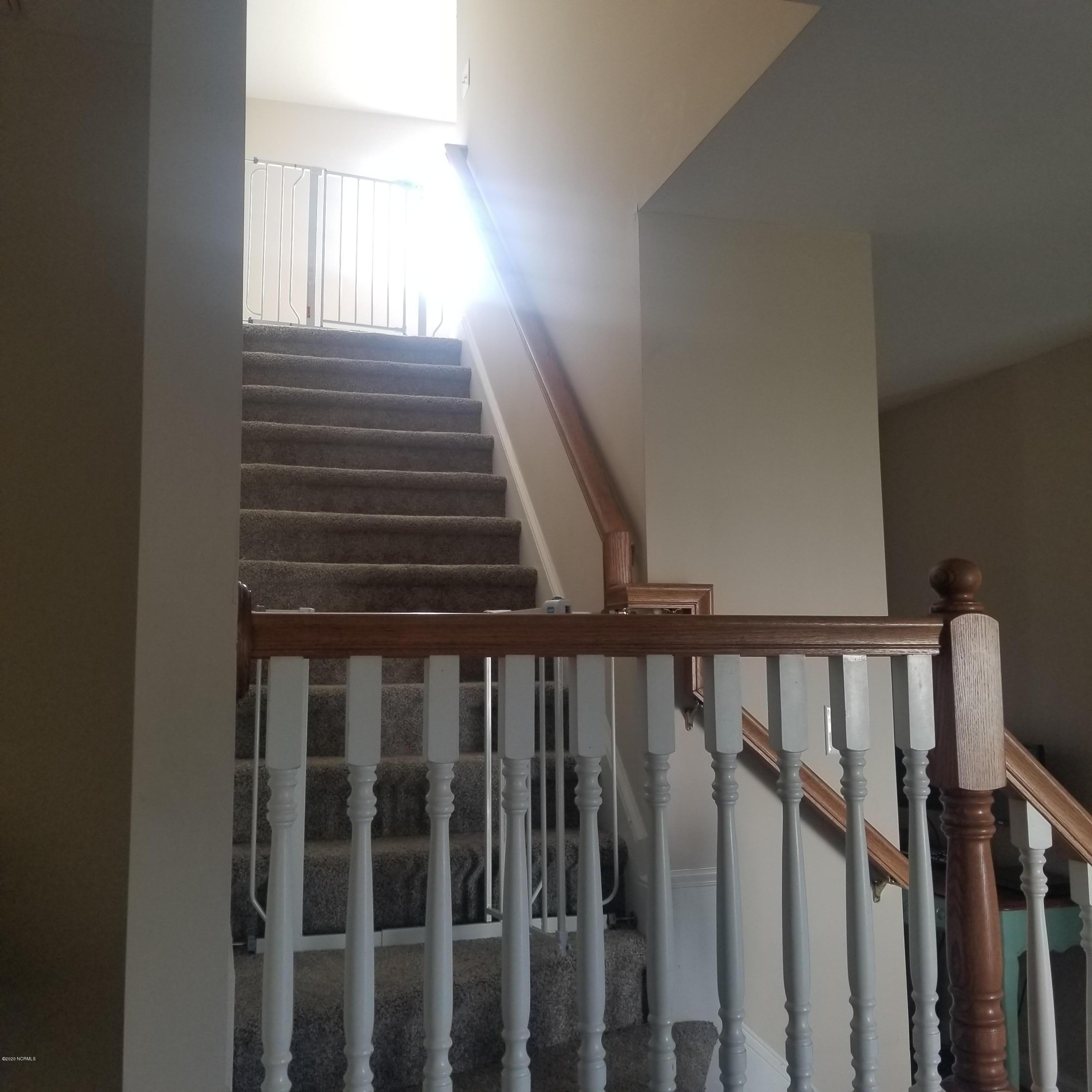 2210 Mayberry Loop Road, Unit B Morehead City, NC 28557 - Photo 16 of 16 staircase with landing to second floor