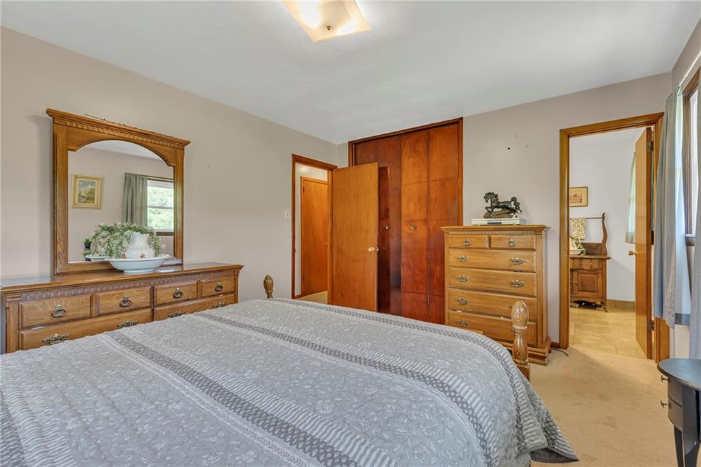 383 Ridgemont Drive Midland, PA 15059 - Photo 35 of 44 a bedroom with a bed and a dresser