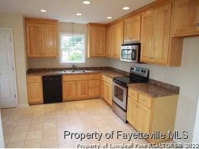 3605 Old Stage Road North Angier, NC 27501 - Photo 3 of 12 a kitchen with stainless steel appliances granite countertop a stove a sink and a microwave