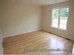 3605 Old Stage Road North Angier, NC 27501 - Photo 5 of 12 an empty room with wooden floor and windows