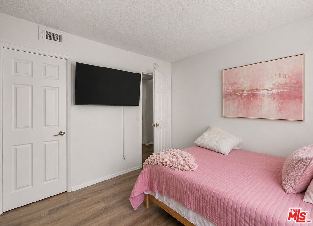 43258 33rd Street West Lancaster, CA 93536 - Photo 20 of 38 a bedroom with a bed and a flat screen tv
