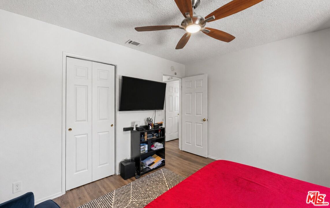 43258 33rd Street West Lancaster, CA 93536 - Photo 23 of 38 a living room with furniture and a flat screen tv