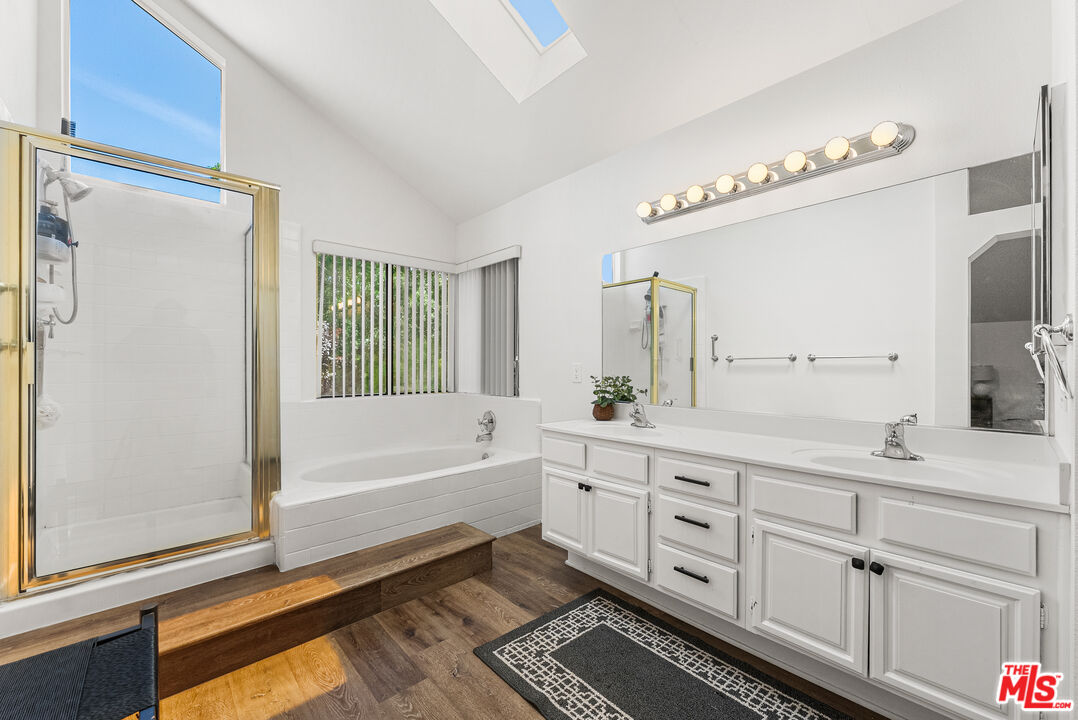 43258 33rd Street West Lancaster, CA 93536 - Photo 27 of 38 a spacious bathroom with a double vanity sink a mirror and a bathtub