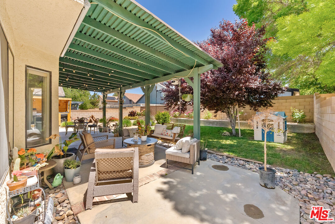 43258 33rd Street West Lancaster, CA 93536 - Photo 30 of 38 a view of a patio with couches chairs and a potted plant
