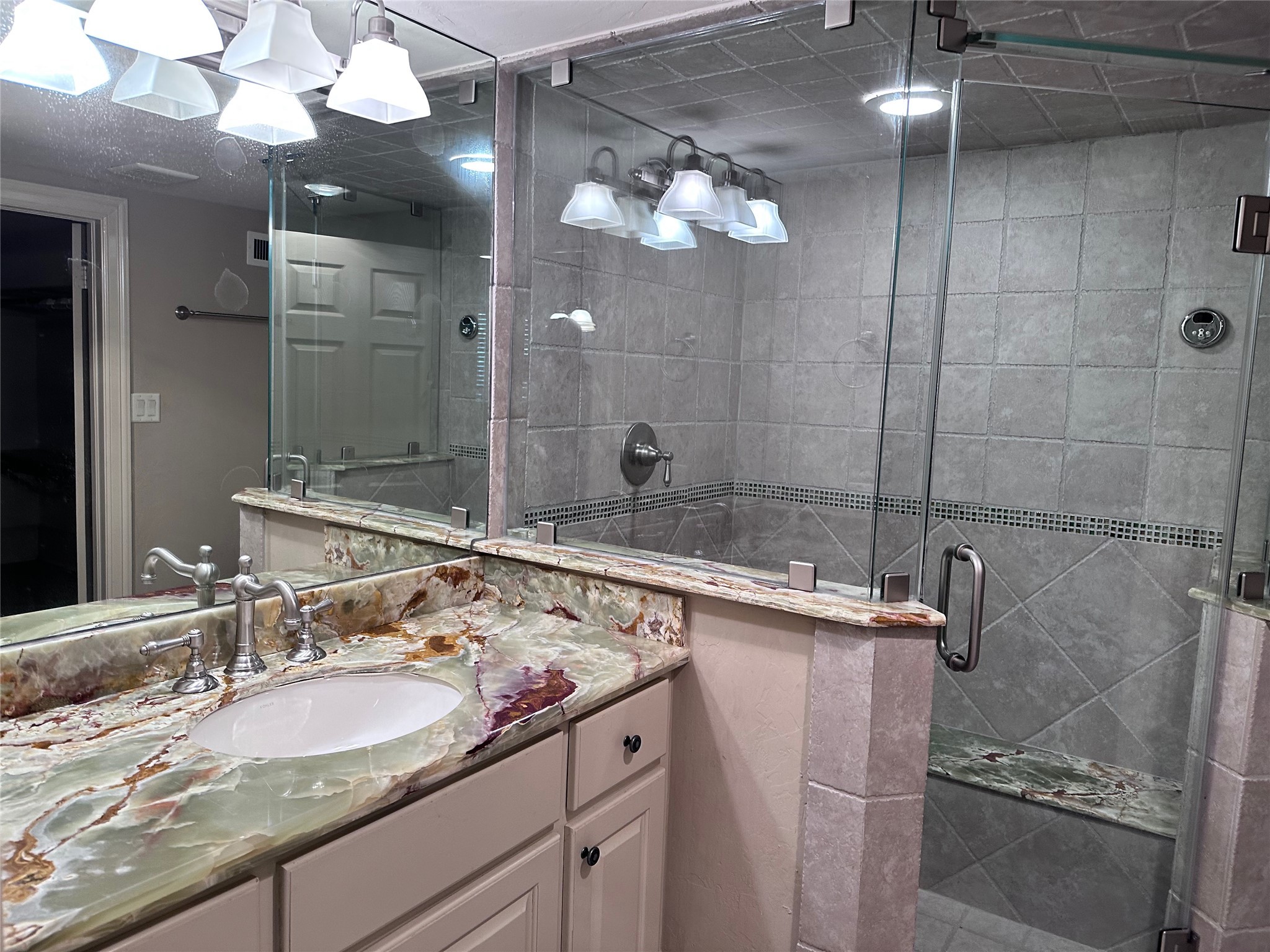 2904 Red Bluff Road Seabrook, TX 77586 - Photo 6 of 16 a bathroom with a sink a large mirror and a shower