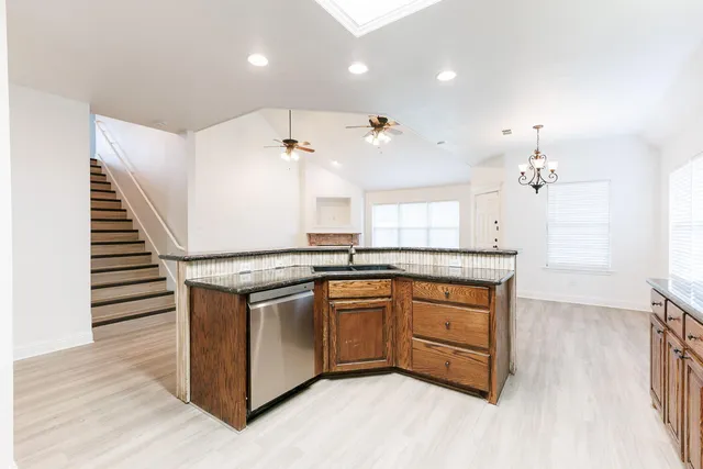 a kitchen with stainless steel appliances granite countertop a stove and a sink
