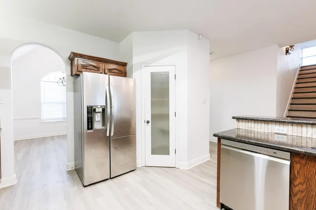 a kitchen with stainless steel appliances a refrigerator and a stove