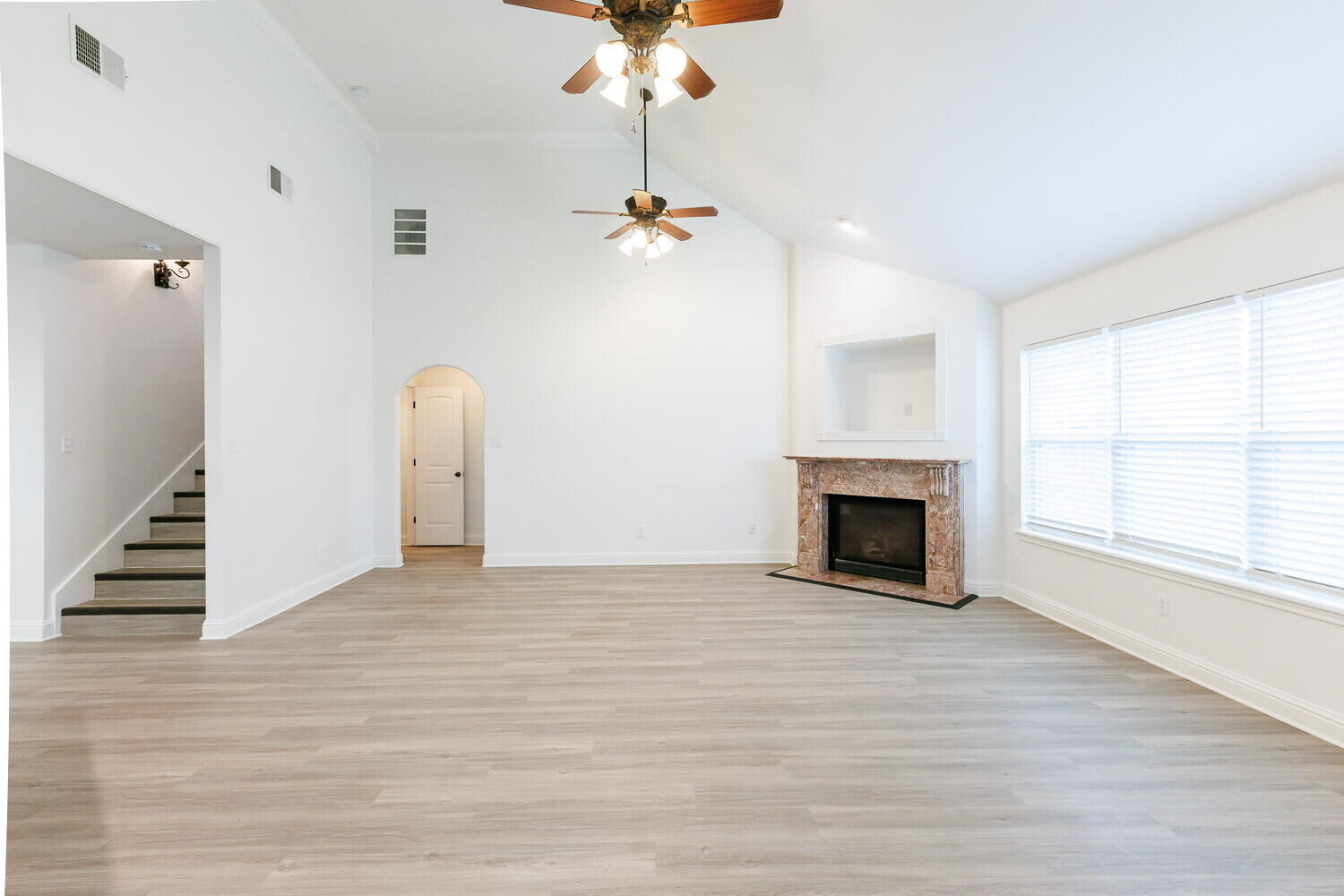 5908 95th Street Lubbock, TX 79424 - Photo 18 of 45 an empty room with windows and fireplace