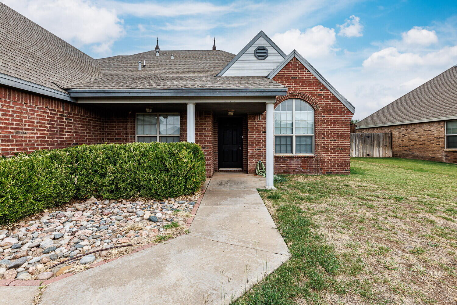 5908 95th Street Lubbock, TX 79424 - Photo 2 of 45 a front view of a house with garden