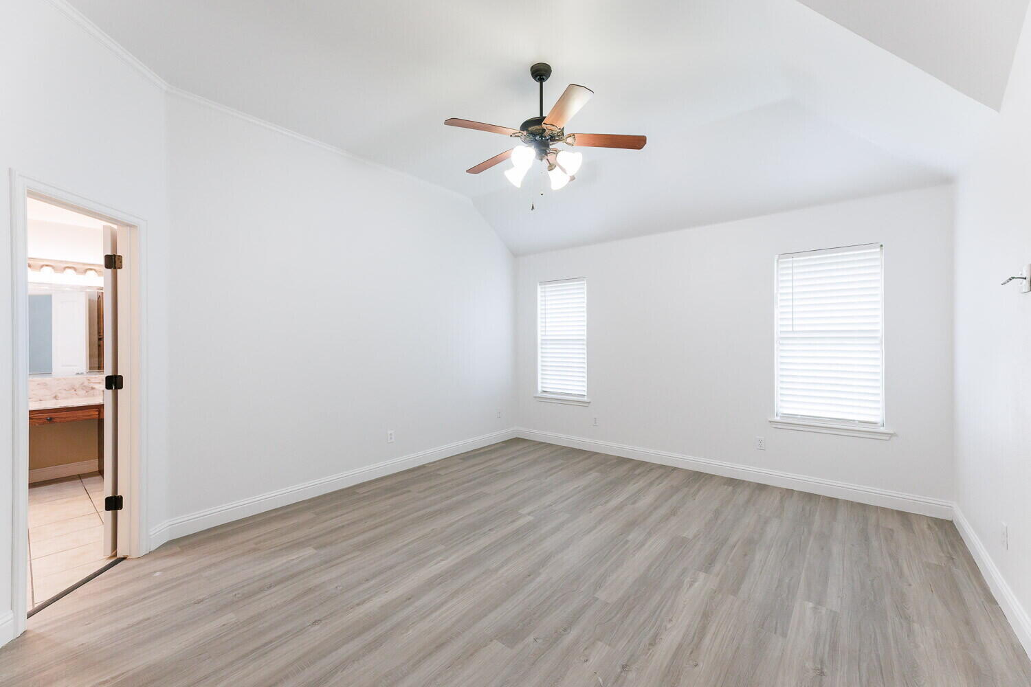 5908 95th Street Lubbock, TX 79424 - Photo 23 of 45 an empty room with wooden floor fan and windows