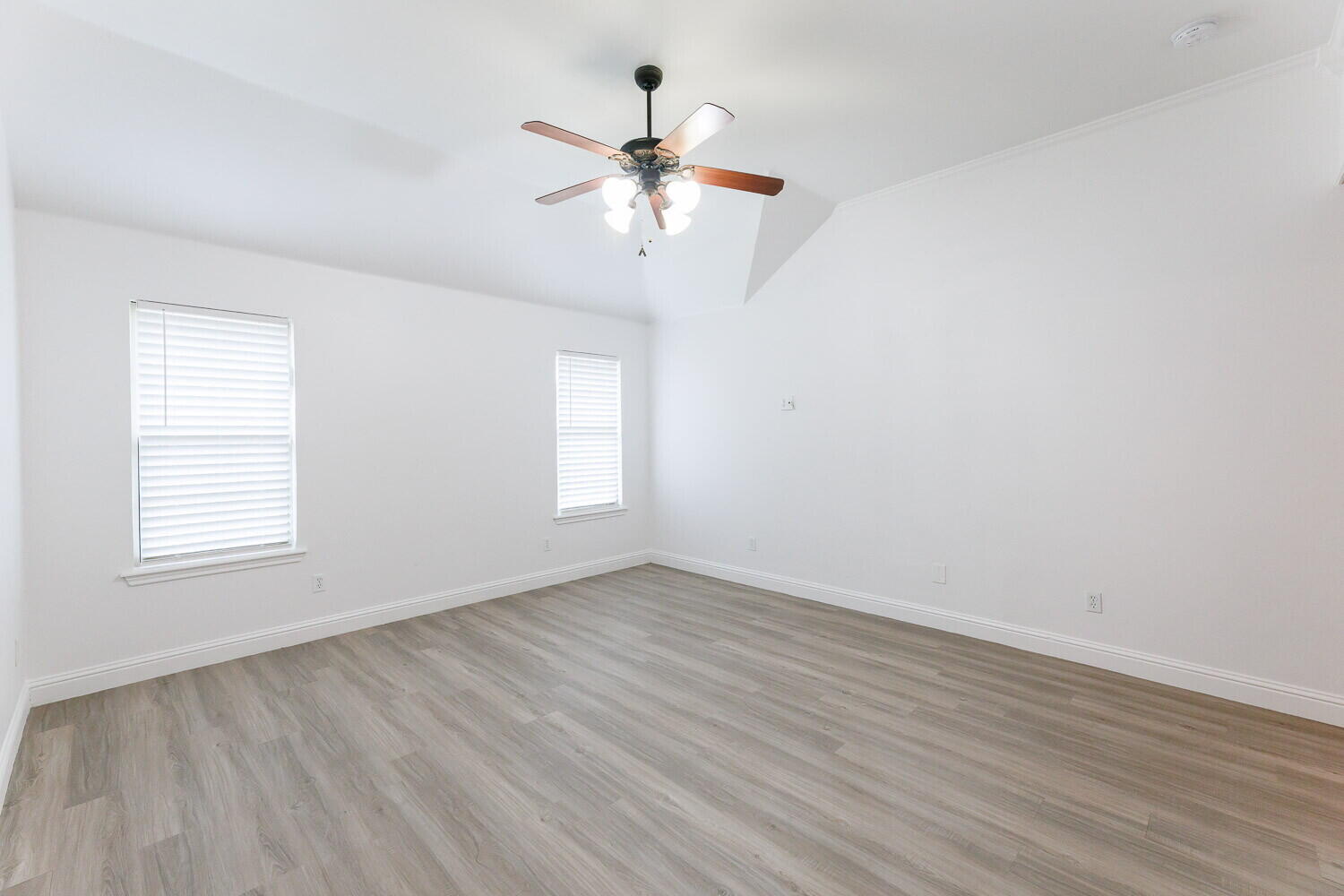 5908 95th Street Lubbock, TX 79424 - Photo 25 of 45 an empty room with wooden floor fan and windows