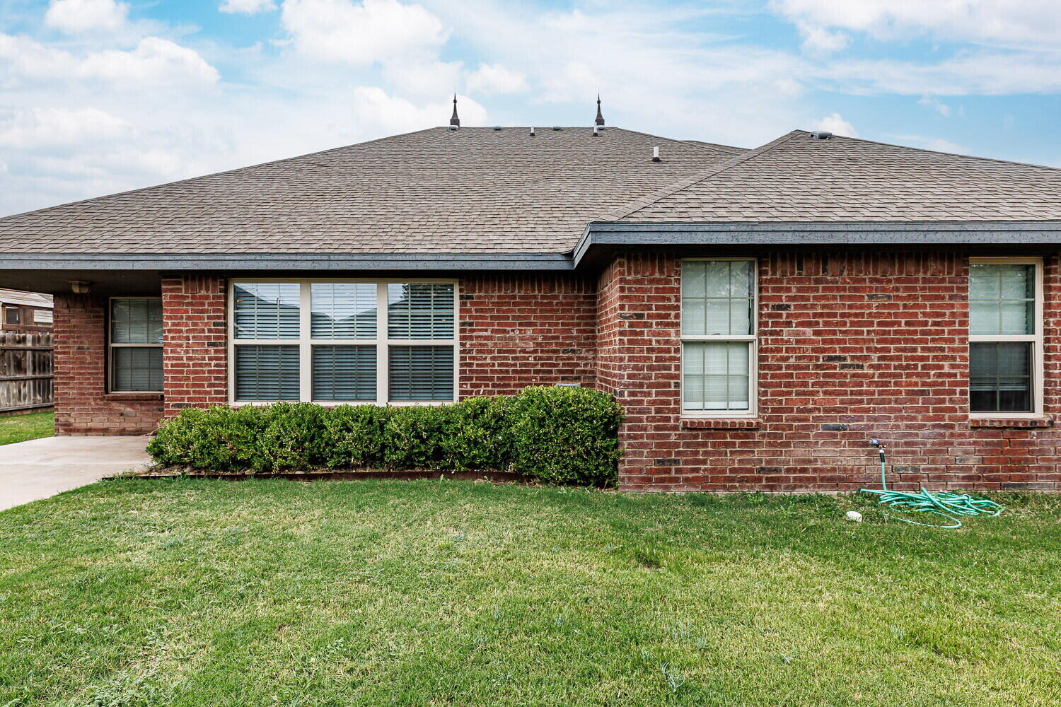 5908 95th Street Lubbock, TX 79424 - Photo 27 of 45 a front view of a house with a garden