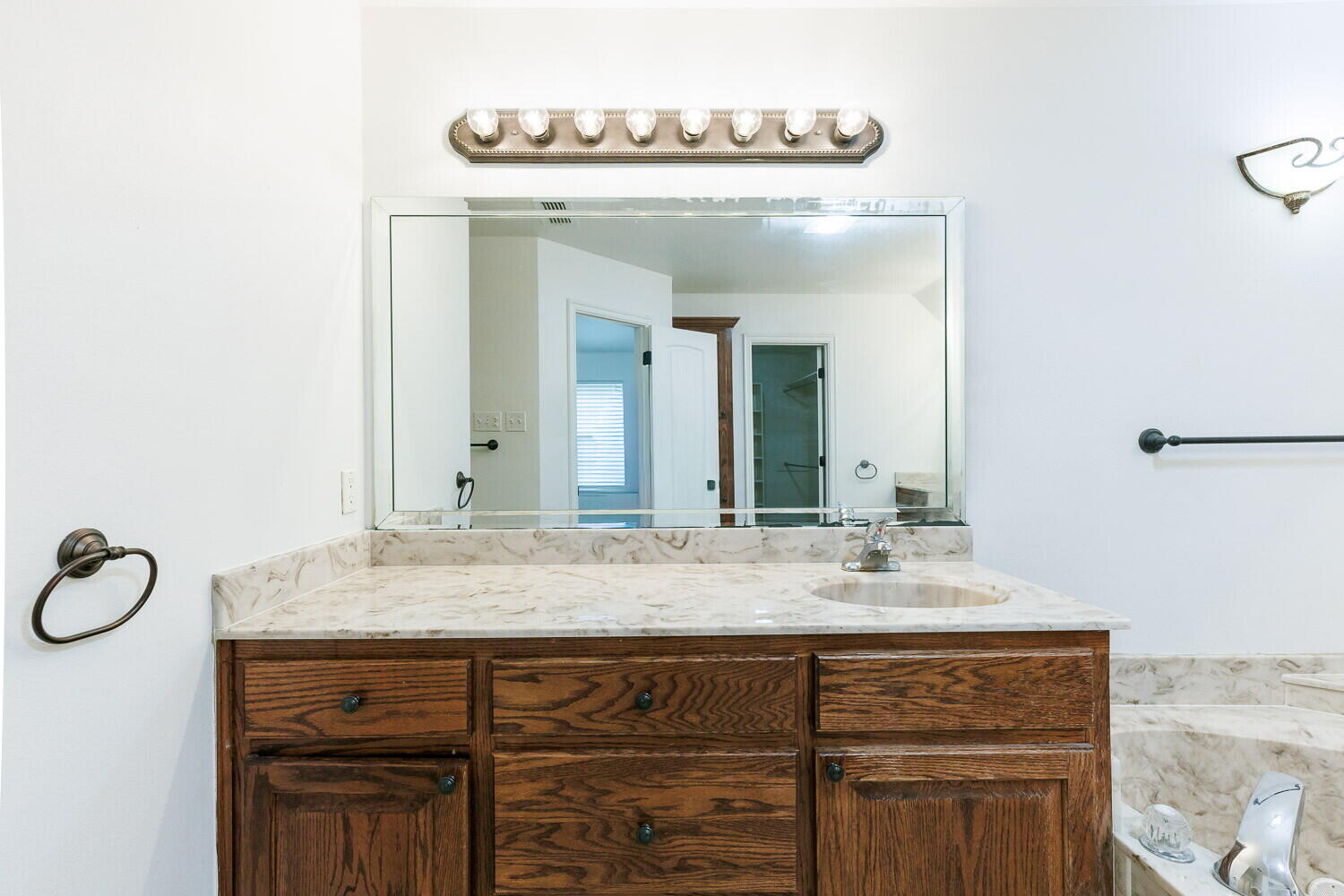 5908 95th Street Lubbock, TX 79424 - Photo 31 of 45 a bathroom with a sink and a mirror