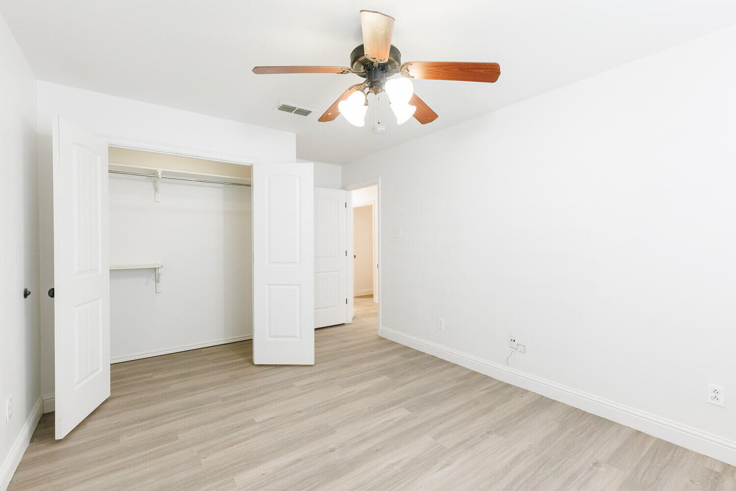 5908 95th Street Lubbock, TX 79424 - Photo 33 of 45 an empty room with wooden floor ceiling fan and window