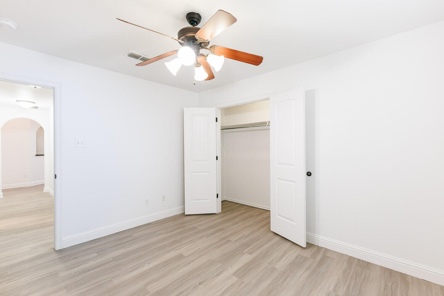 5908 95th Street Lubbock, TX 79424 - Photo 36 of 45 a view of a room with wooden floor and ceiling fan