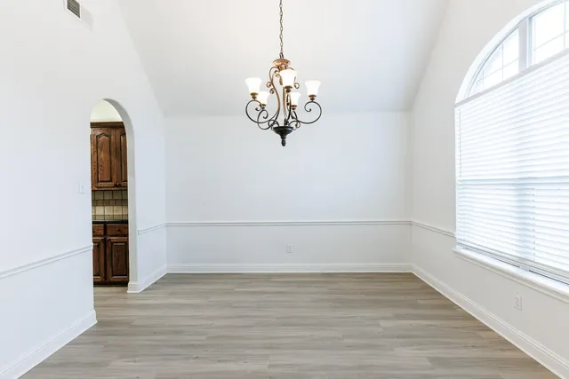 a view of wooden floor and window in a room