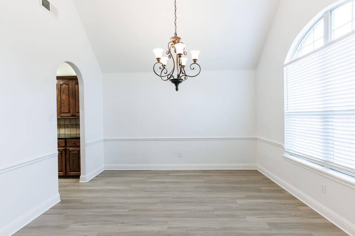 5908 95th Street Lubbock, TX 79424 - Photo 5 of 45 a view of wooden floor and window in a room