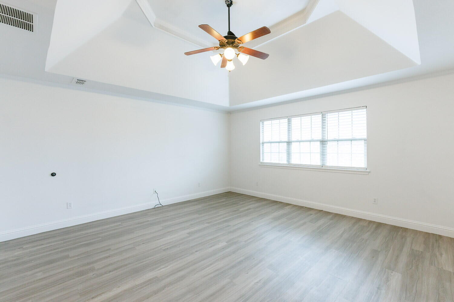 5908 95th Street Lubbock, TX 79424 - Photo 9 of 45 an empty room with wooden floor and windows