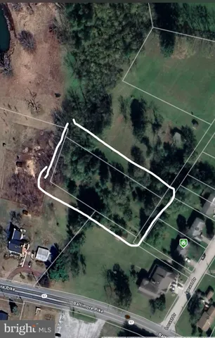 a view of a tennis ground with large trees