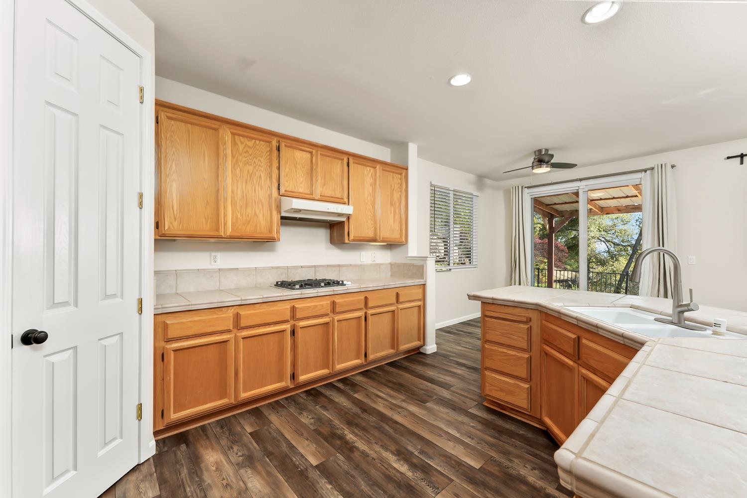 4285 Crazy Horse Road Cameron Park, CA 95682 - Photo 29 of 91 a large kitchen with stainless steel appliances granite countertop a sink and cabinets with wooden floor