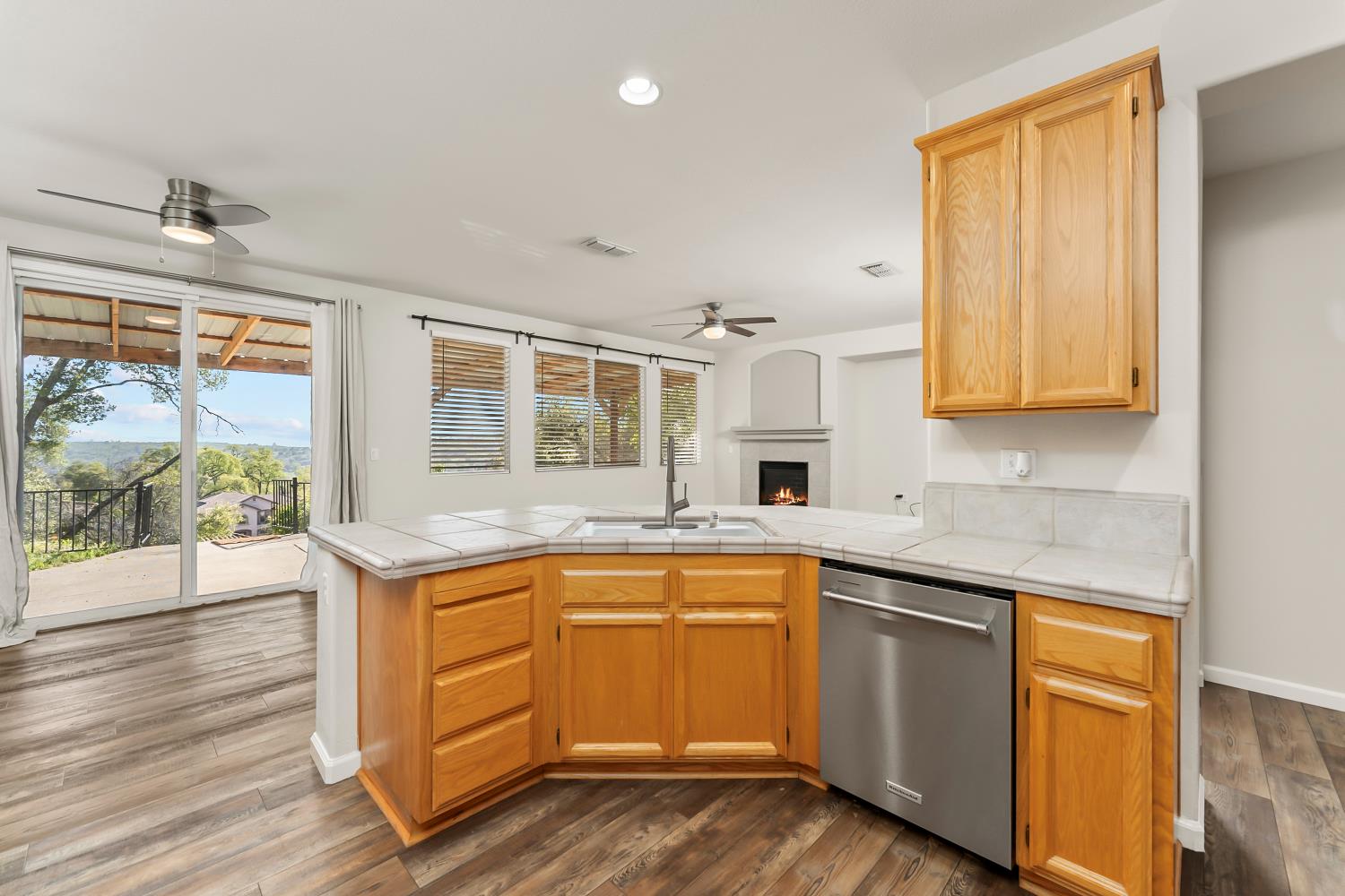 4285 Crazy Horse Road Cameron Park, CA 95682 - Photo 30 of 91 a kitchen with a sink stove and wooden cabinets