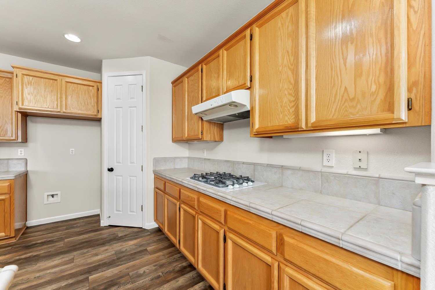 4285 Crazy Horse Road Cameron Park, CA 95682 - Photo 32 of 91 a kitchen with stainless steel appliances granite countertop a stove a sink and a microwave