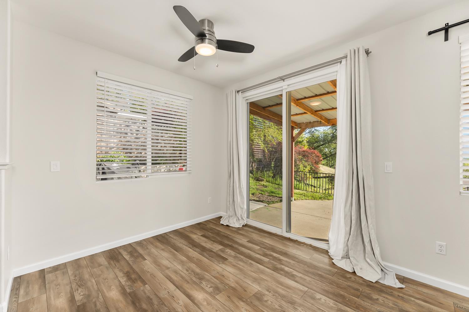 4285 Crazy Horse Road Cameron Park, CA 95682 - Photo 33 of 91 an empty room with wooden floor and windows