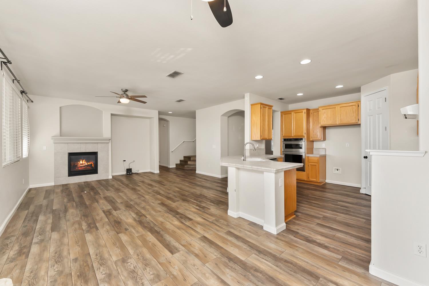 4285 Crazy Horse Road Cameron Park, CA 95682 - Photo 35 of 91 an open kitchen with white cabinets and stainless steel appliances