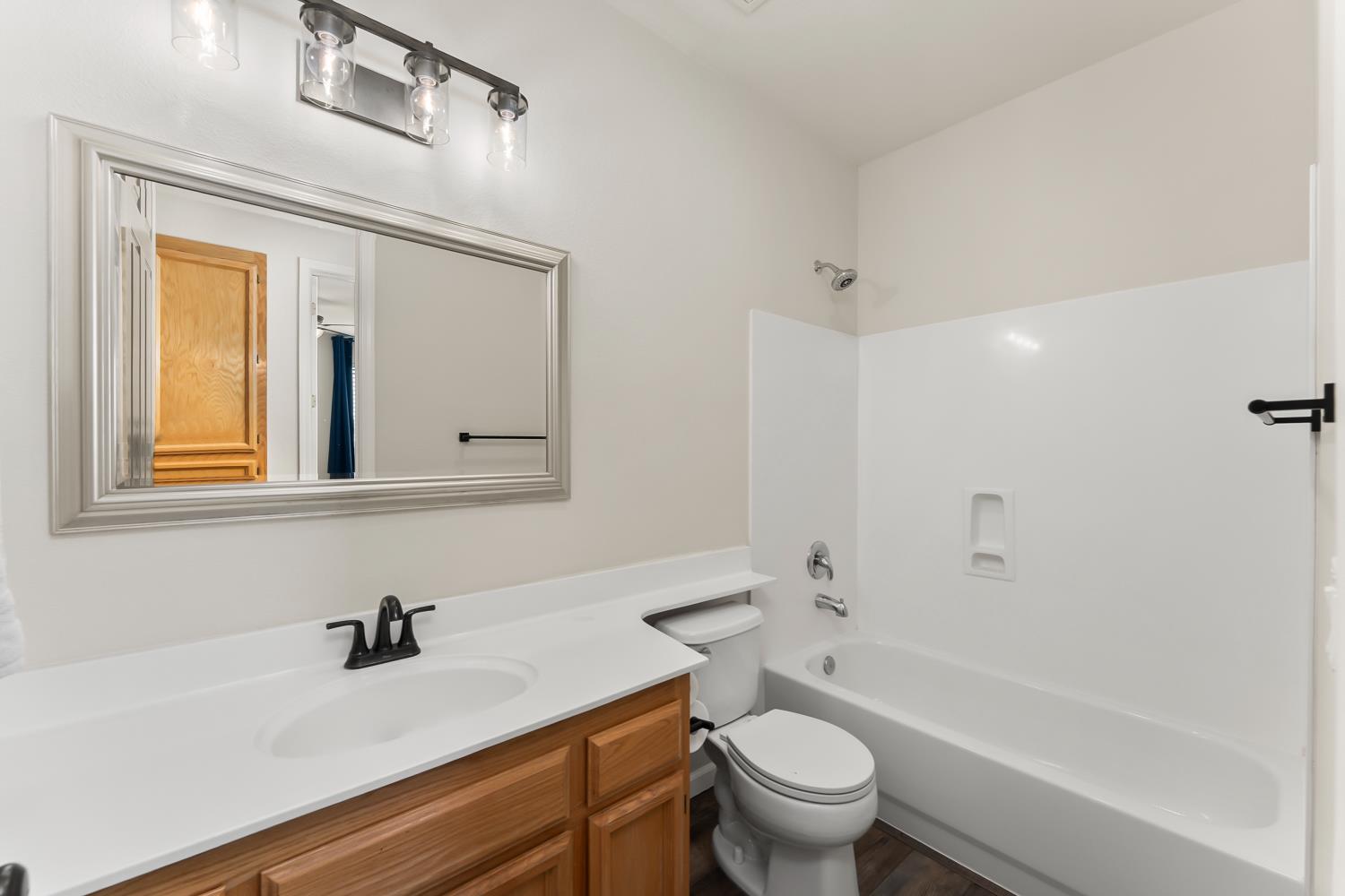 4285 Crazy Horse Road Cameron Park, CA 95682 - Photo 45 of 91 a bathroom with a granite countertop sink a toilet and a mirror