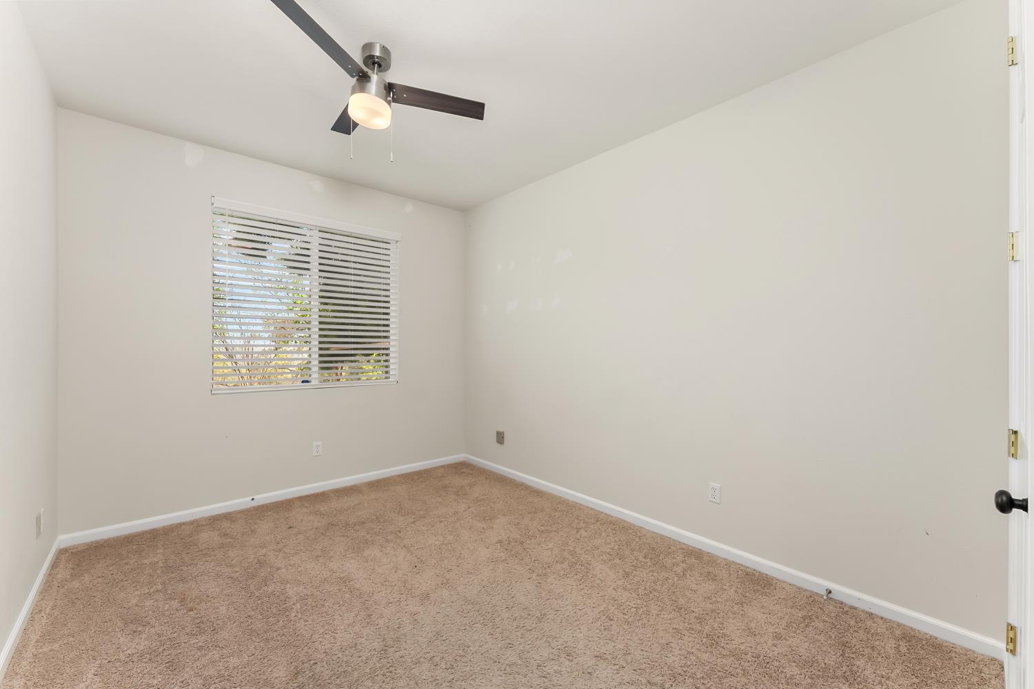 4285 Crazy Horse Road Cameron Park, CA 95682 - Photo 46 of 91 an empty room with a window and a fan