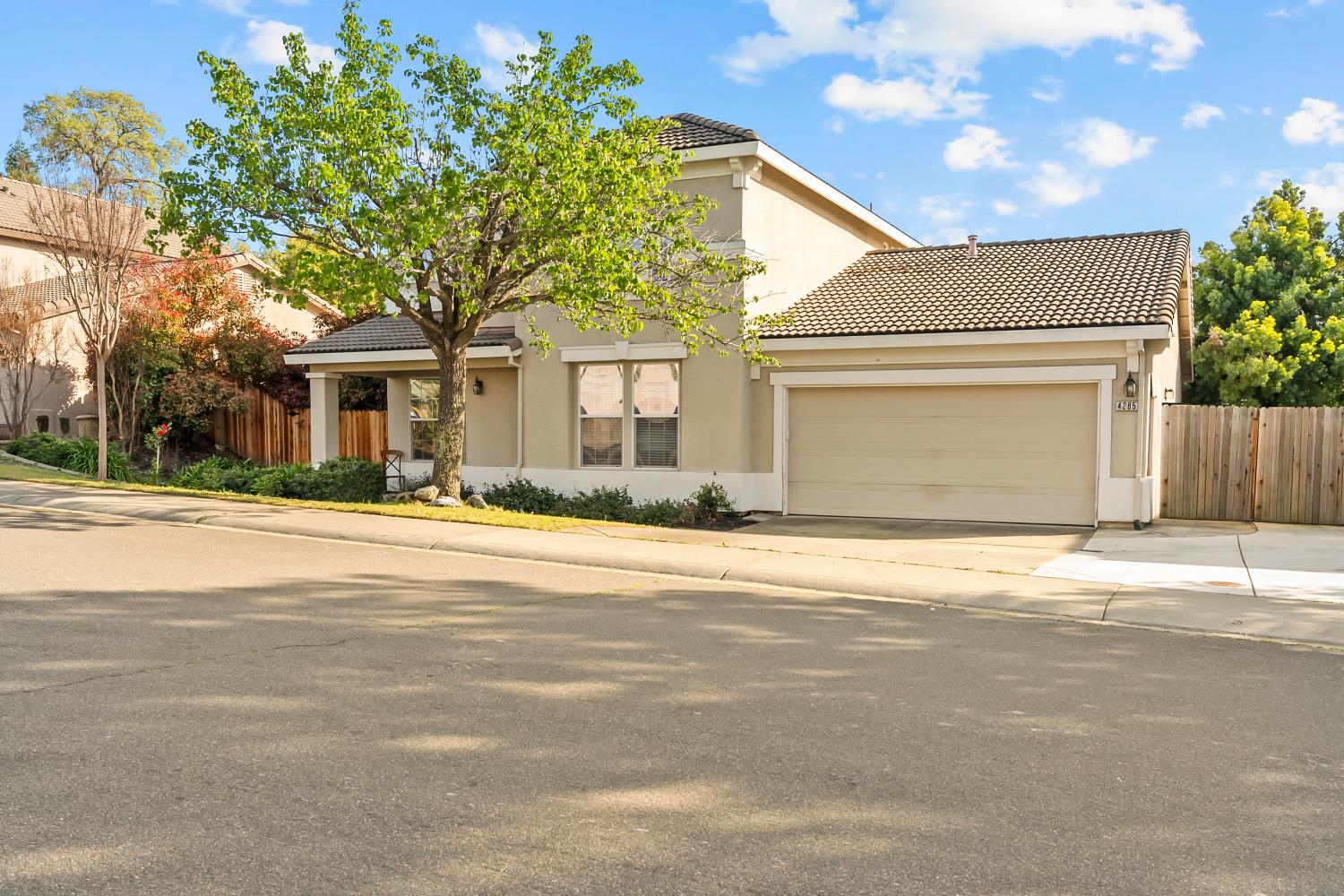 4285 Crazy Horse Road Cameron Park, CA 95682 - Photo 5 of 91 a front view of a house with a road and garage