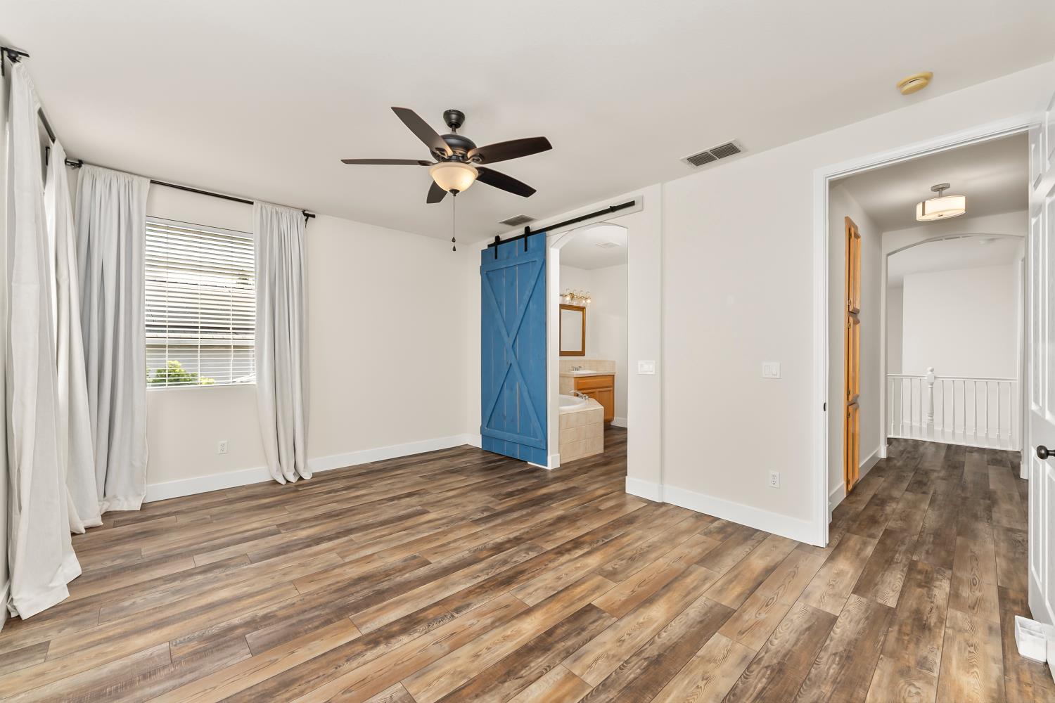 4285 Crazy Horse Road Cameron Park, CA 95682 - Photo 59 of 91 a view of empty room with wooden floor and fan