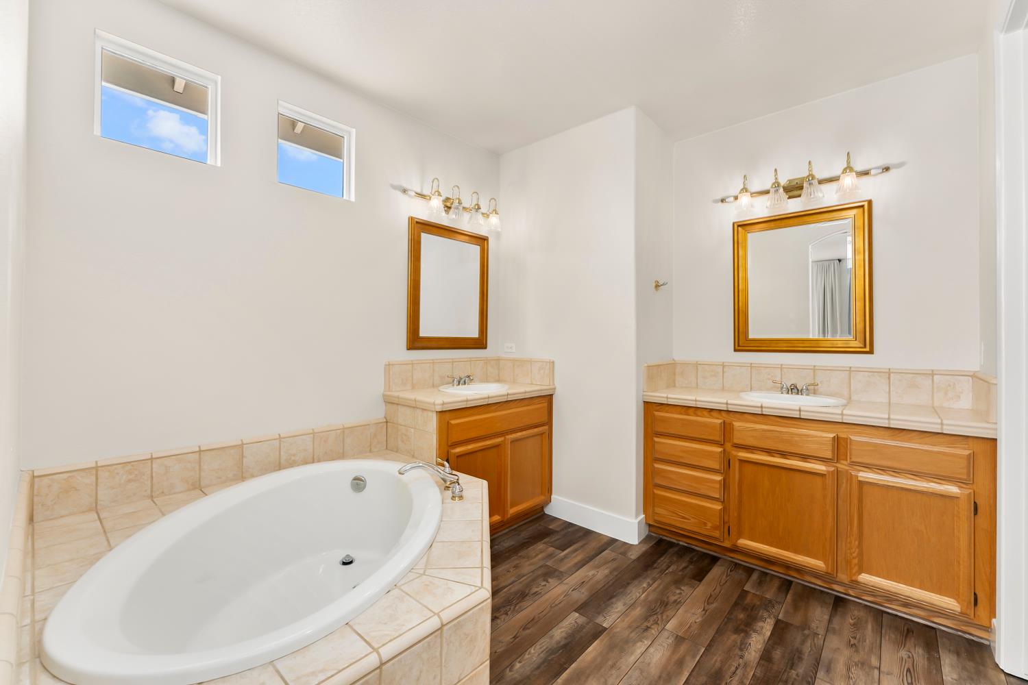 4285 Crazy Horse Road Cameron Park, CA 95682 - Photo 62 of 91 a bathroom with a bathtub sink and mirror