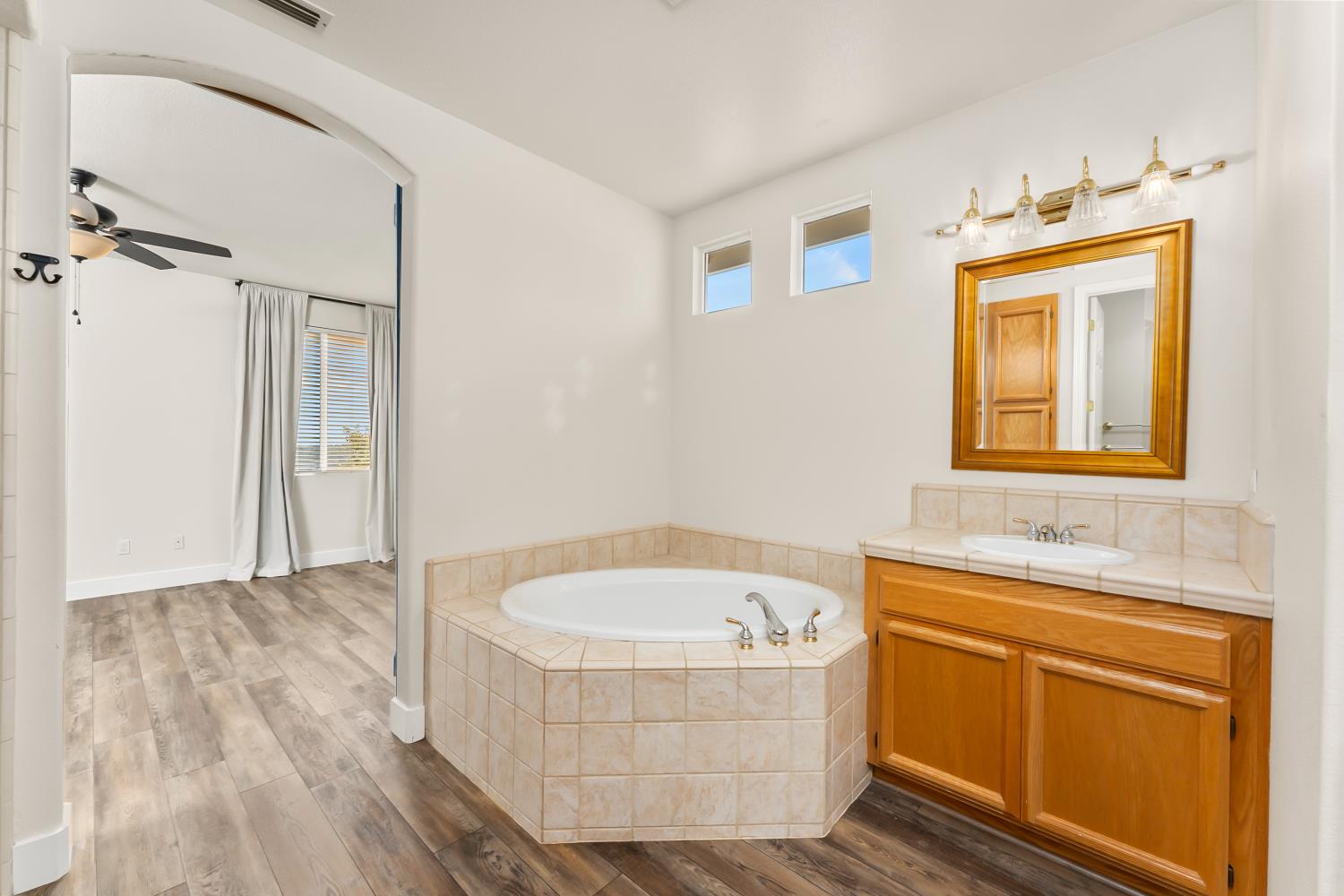 4285 Crazy Horse Road Cameron Park, CA 95682 - Photo 63 of 91 a bathroom with a tub sink and mirror