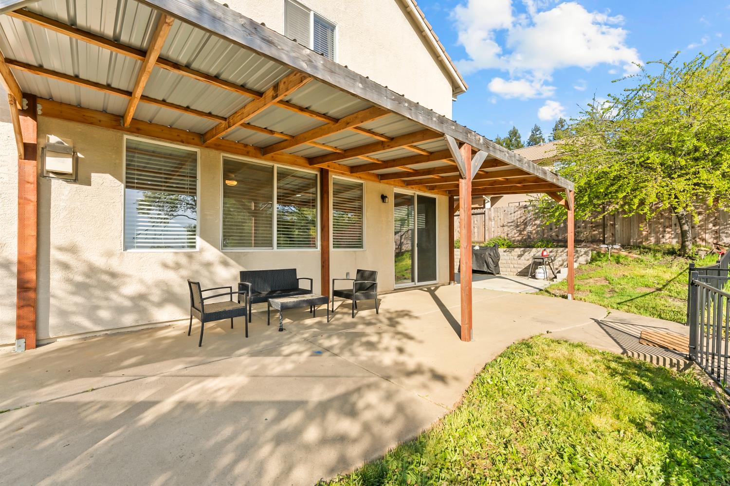4285 Crazy Horse Road Cameron Park, CA 95682 - Photo 71 of 91 a view of a patio with table and chairs and floor to ceiling window with yard