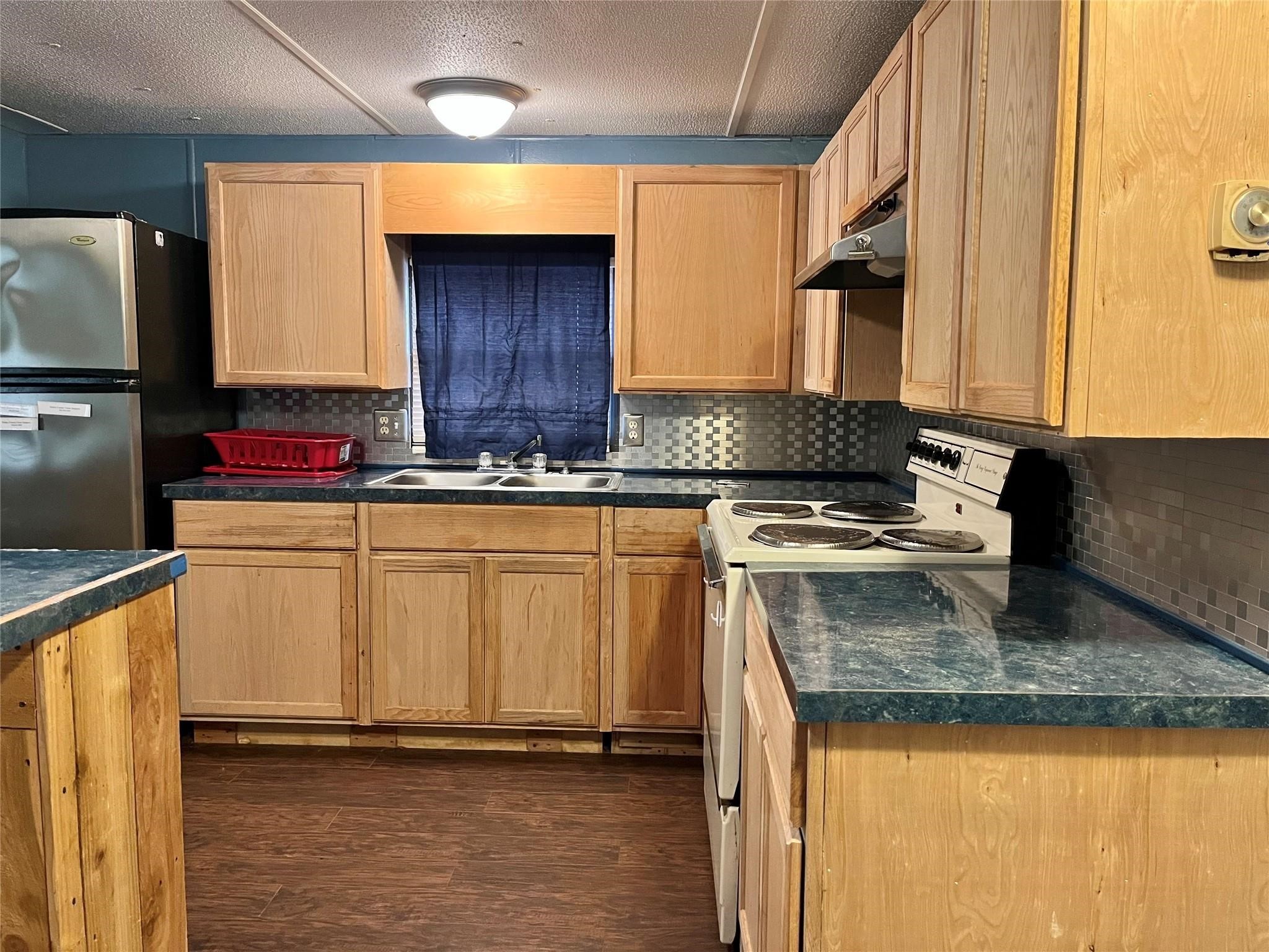 1171 Cardinal Lane Trinity, TX 75862 - Photo 3 of 14 a kitchen with stainless steel appliances granite countertop a sink stove and cabinets