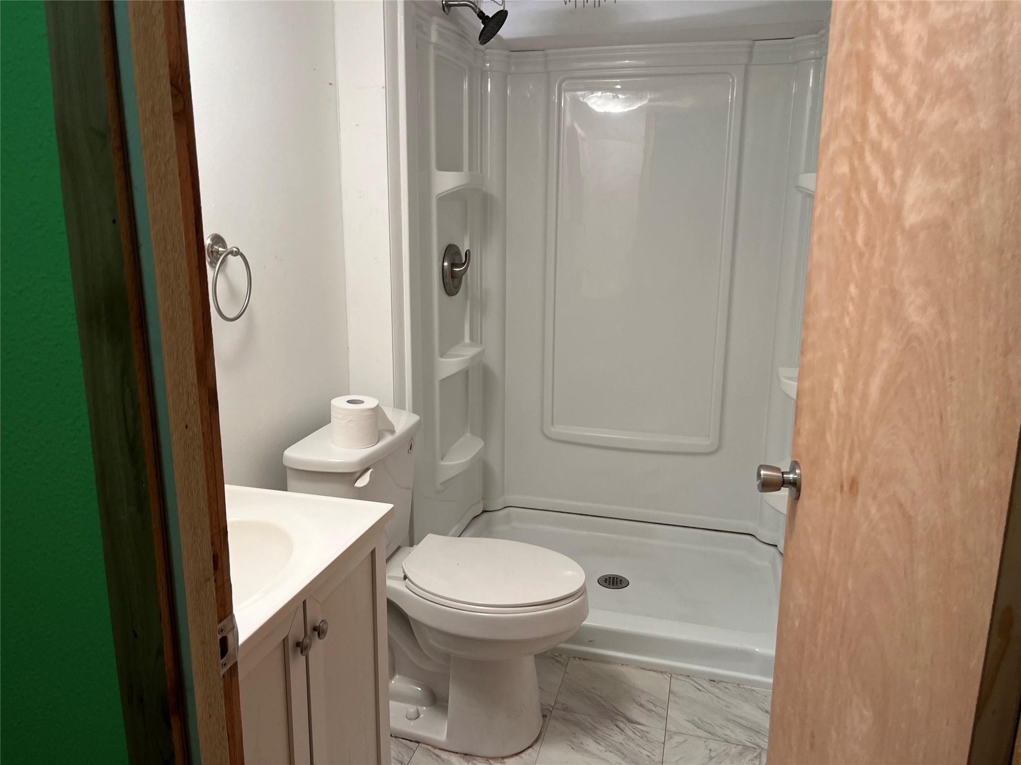 1171 Cardinal Lane Trinity, TX 75862 - Photo 5 of 14 a bathroom with a toilet a sink and shower