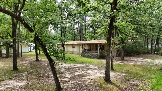 a view of a house with a backyard