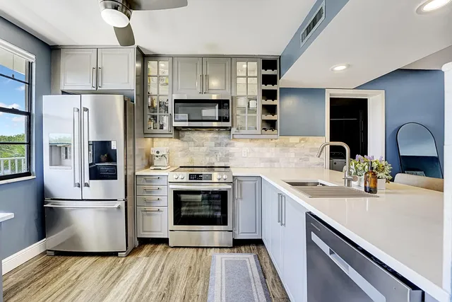 a kitchen with stainless steel appliances a sink cabinets and a counter top space