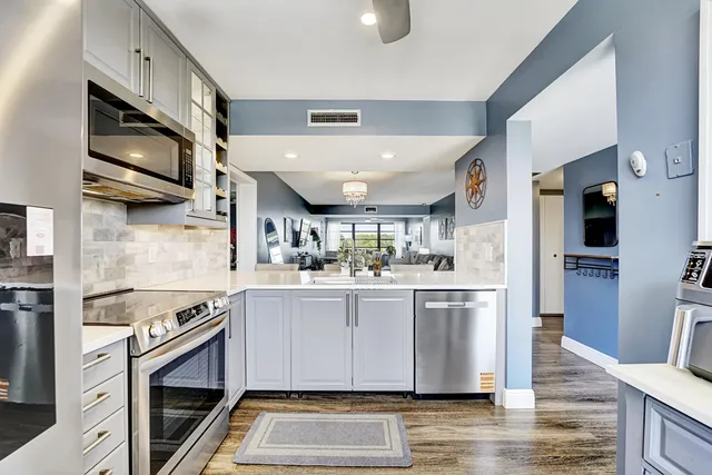 a kitchen with stainless steel appliances granite countertop a stove and a sink